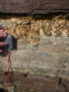 Pegmatite at the top of a granite sheet on contact with the country rock