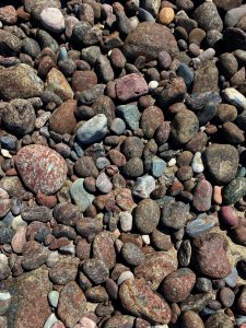 Schist and red serpentinite pebbles on the beach